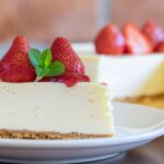 Firefly_A delicious cheesecake slice with two strawberries on it, strawberry jam and mint lea 142551
