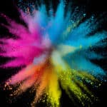 A centered explosion of colorful powder on a black background